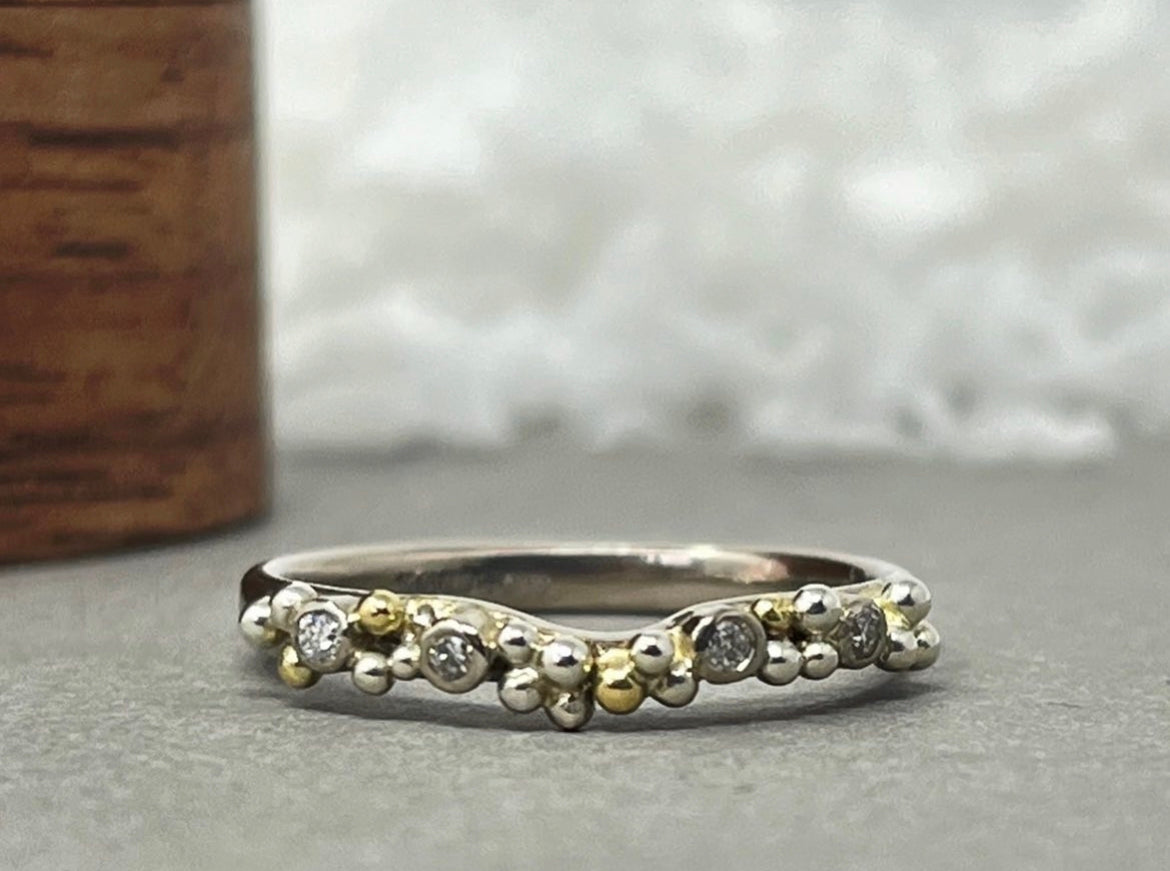 Silver and gold ring with tiny spheres and intermittently placed diamonds